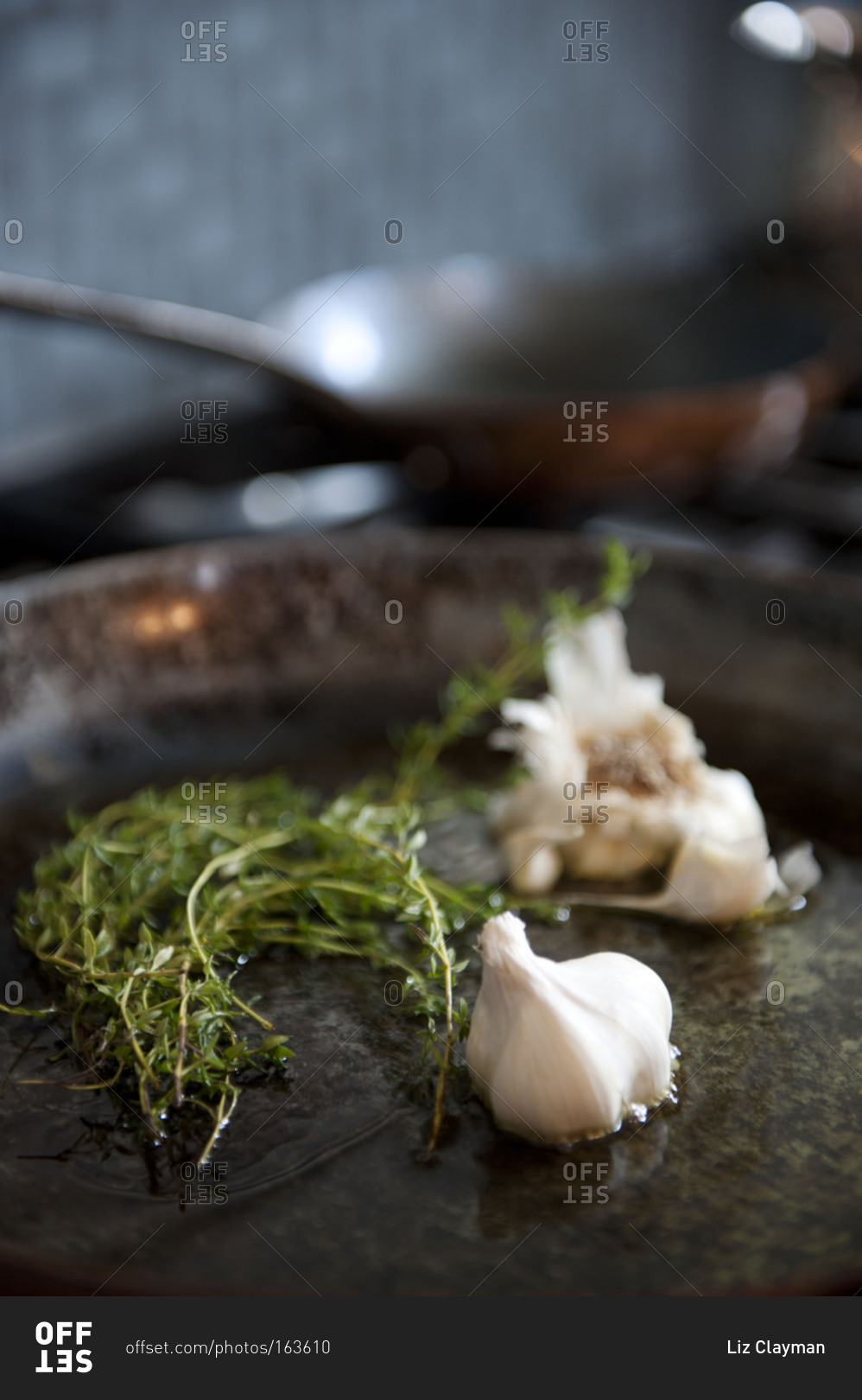 Thyme and whole garlic in a seasoned skillet