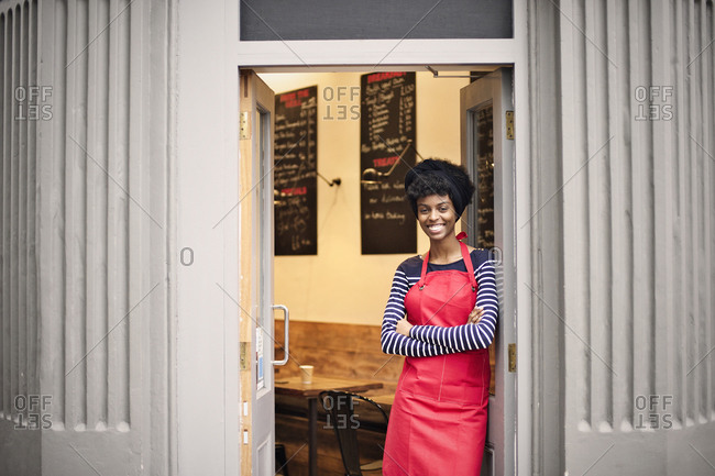 Waitress smiling in door of cafe