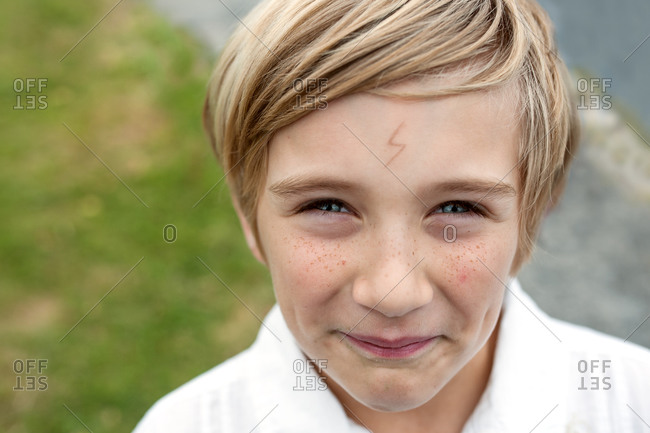 Smiling Boy With Lightning Bolt Tattoo On Forehead Stock Photo Offset