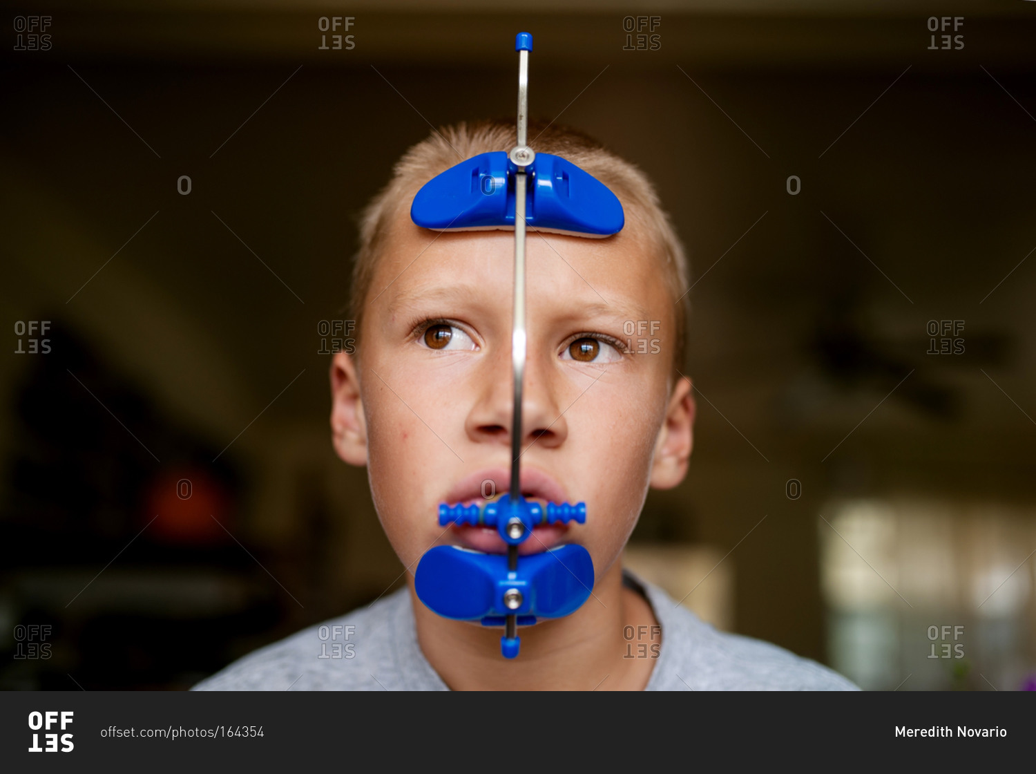 Boy wearing orthodontic headgear stock photo OFFSET