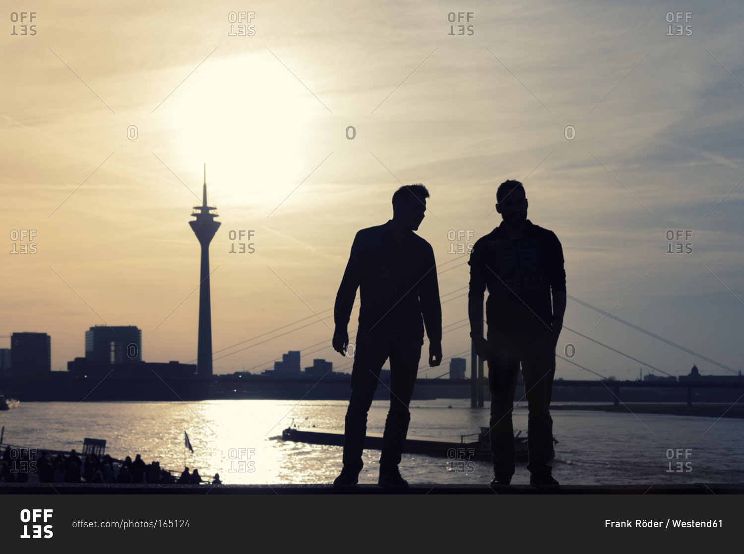 Two man looking to Rhine tower and Rhine river at sunset, Dusseldorf