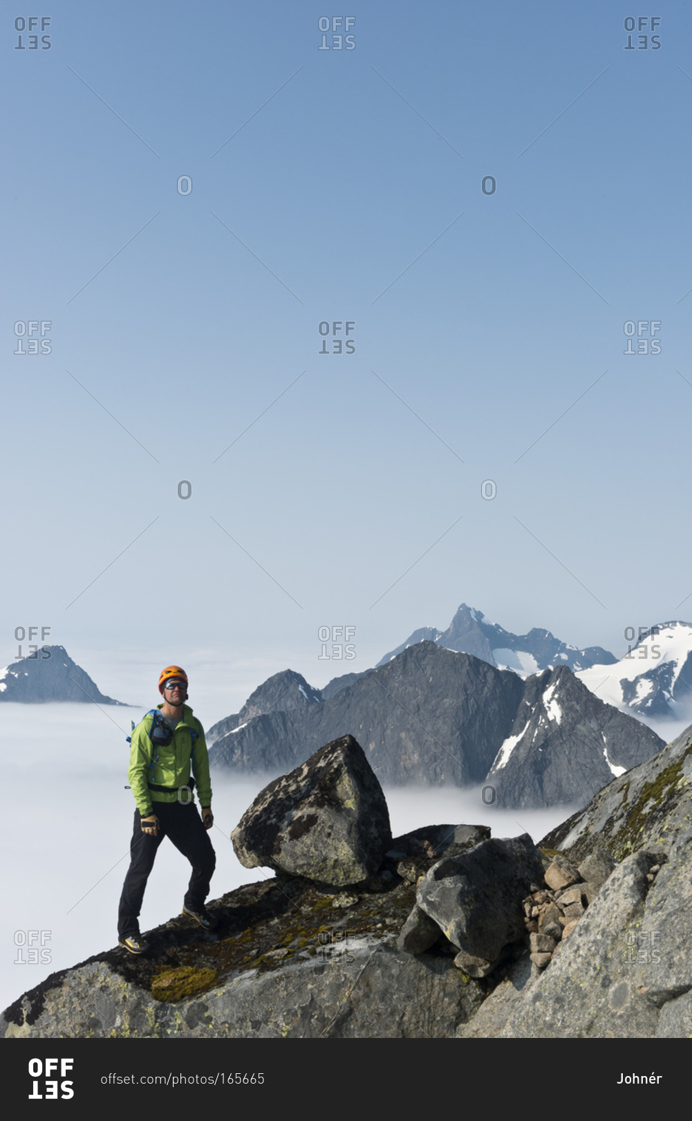 Hiker standing on top of mountain