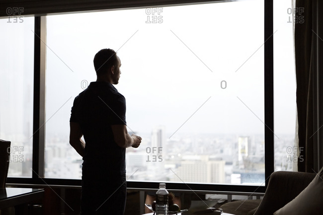 man looking through a window