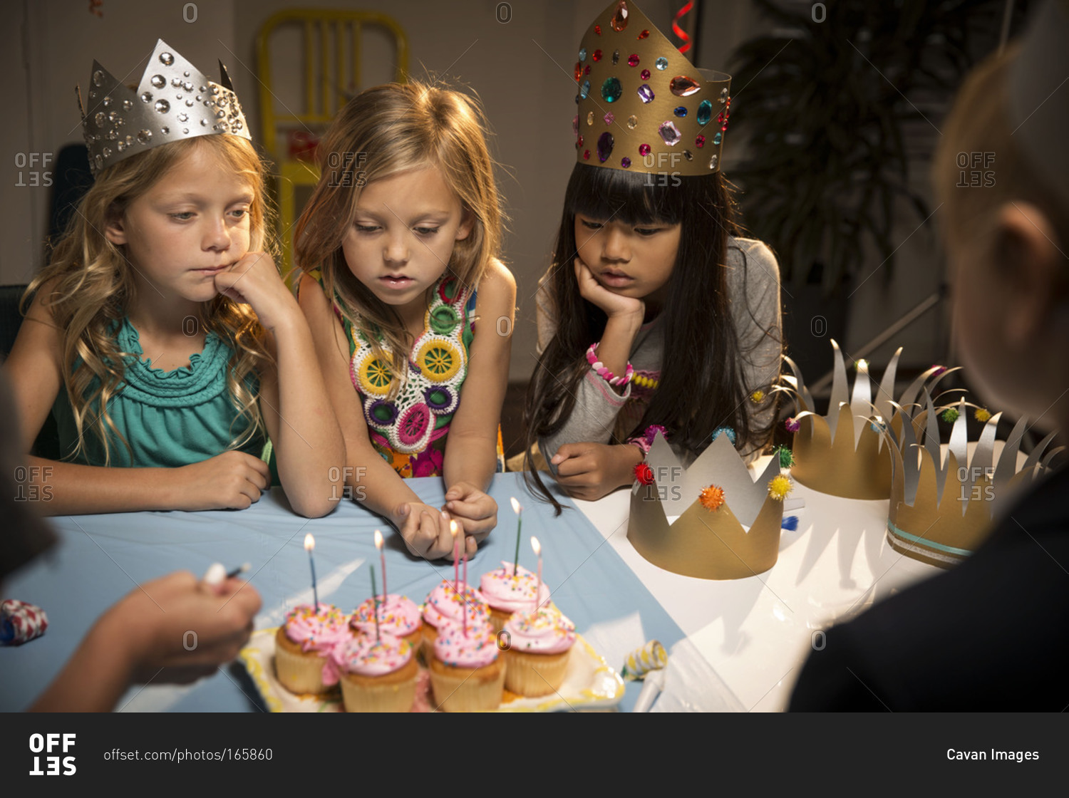 Children at birthday party watch candles being lighted
