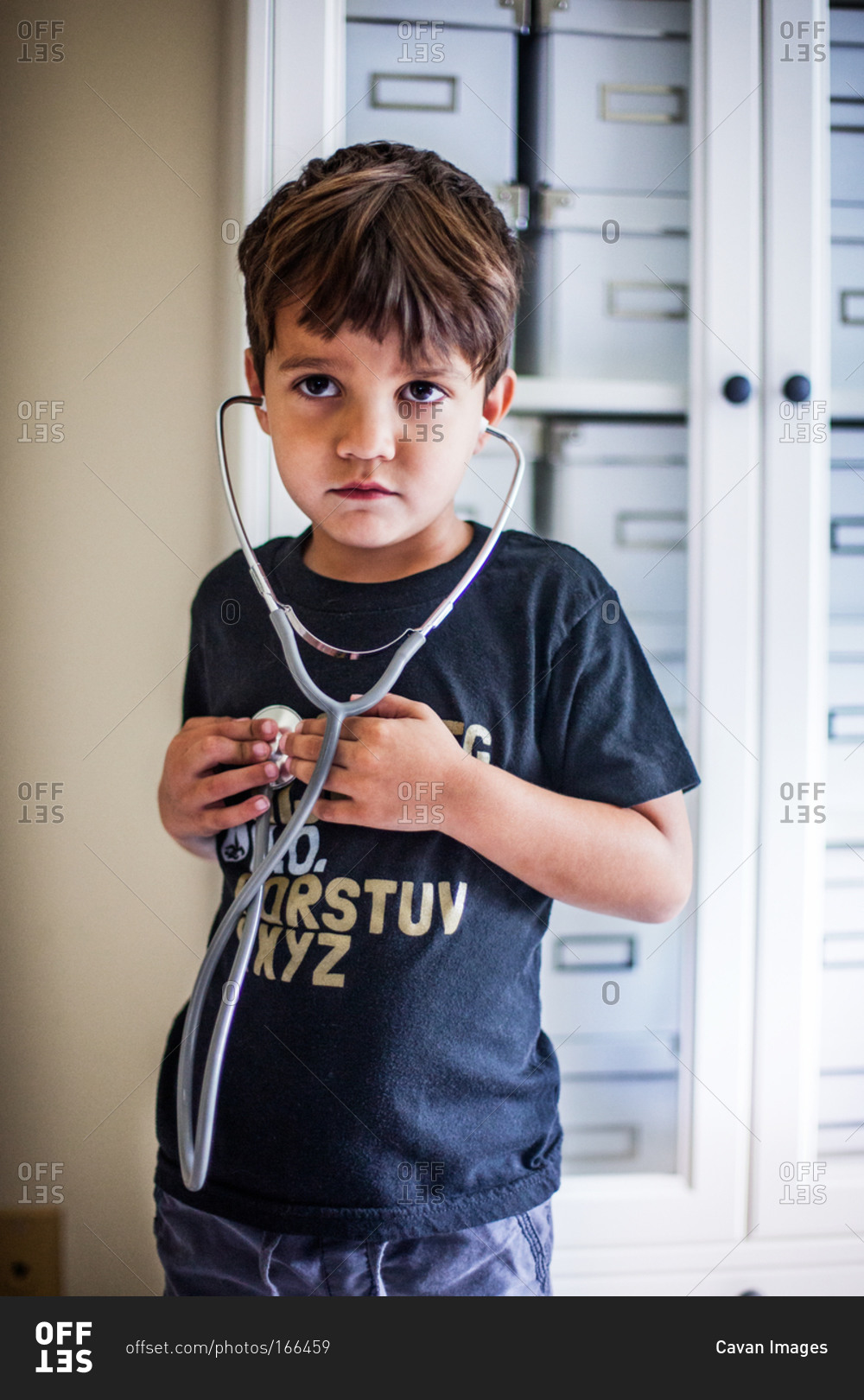 Boy listening to his heart with stethoscope stock photo OFFSET