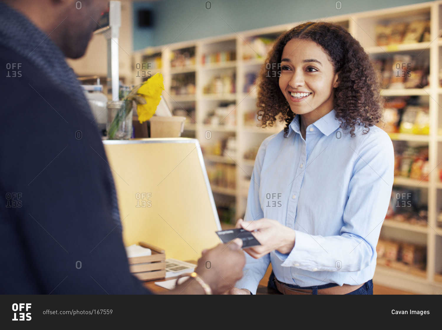 Cashier accepting a credit card from a customer