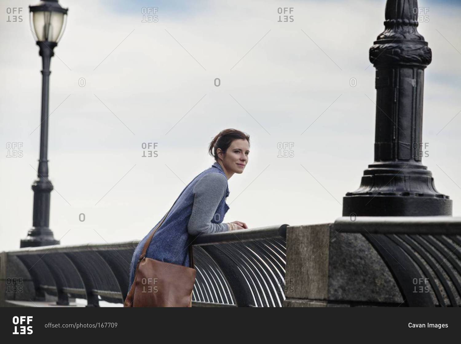 Woman Leaning On Bridge Railing Stock Photo Offset