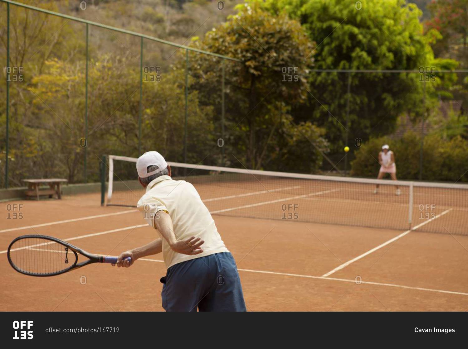 Husband and wife playing tennis