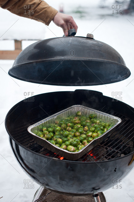 Brussels sprouts roasting on a charcoal grill