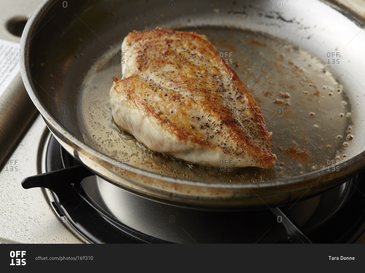 Chicken breast roasting in a pan