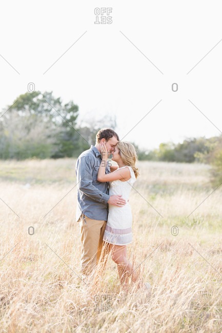 Couple kissing in a field