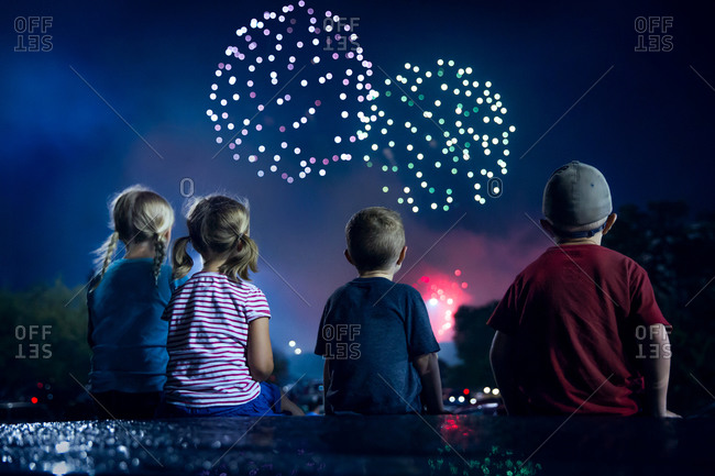 Children Watching Fireworks Display From A Rooftop Stock Photo Offset