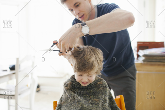 Premium Photo  Hairdresser making hairstyle family day mother cutting  hair to father and little son shaving dad beard with razor