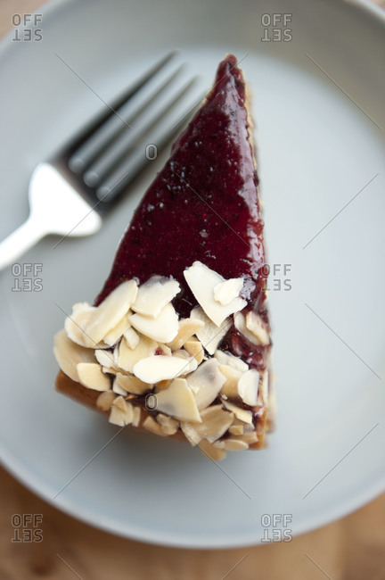 Overhead shot of a slice of raspberry almond cake on a plate
