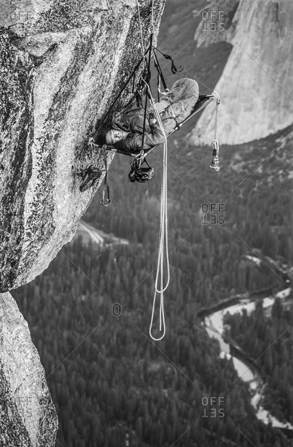 Sleeping man in a rock climbing bivouac