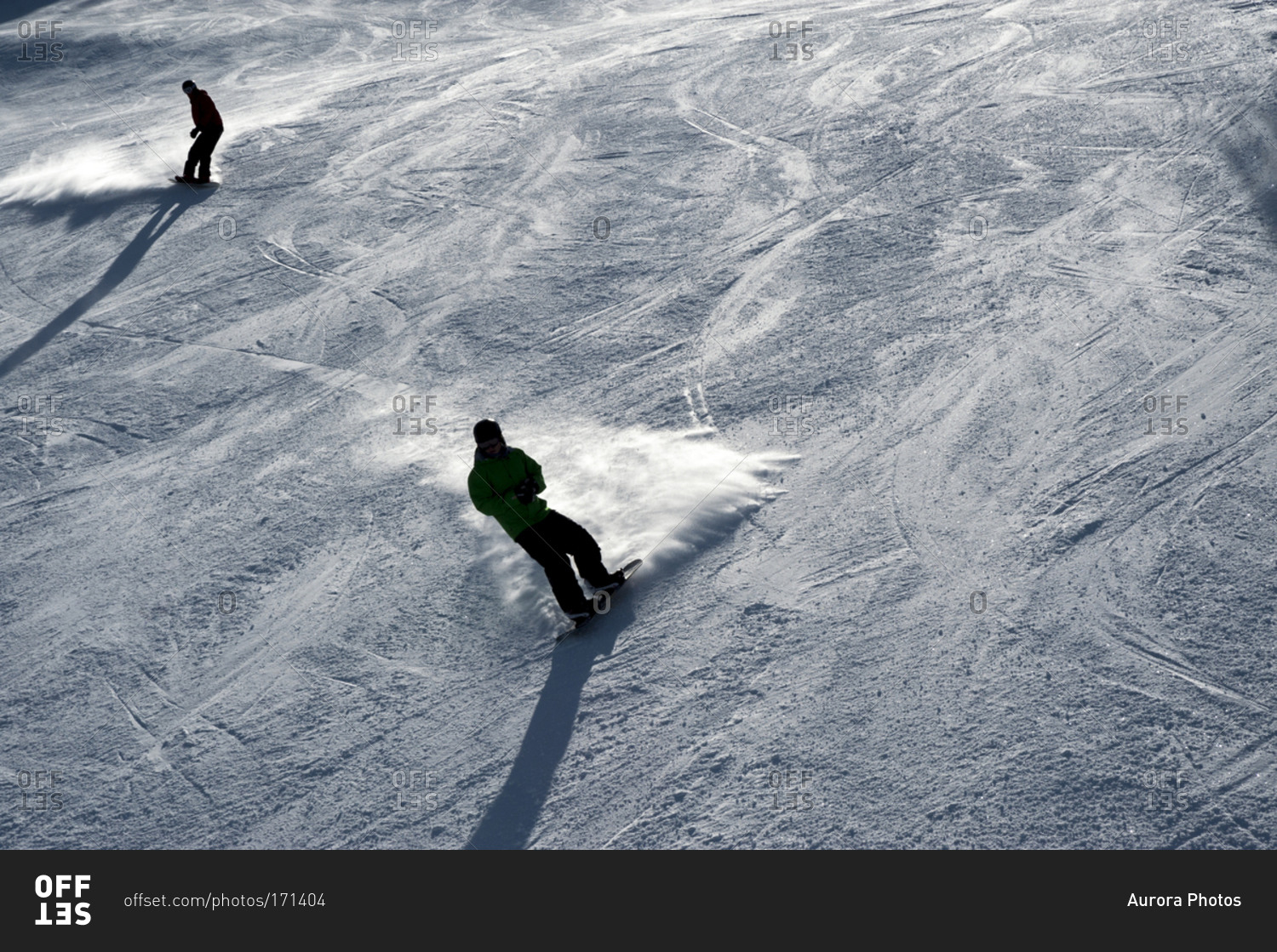 Two people snowboarding.