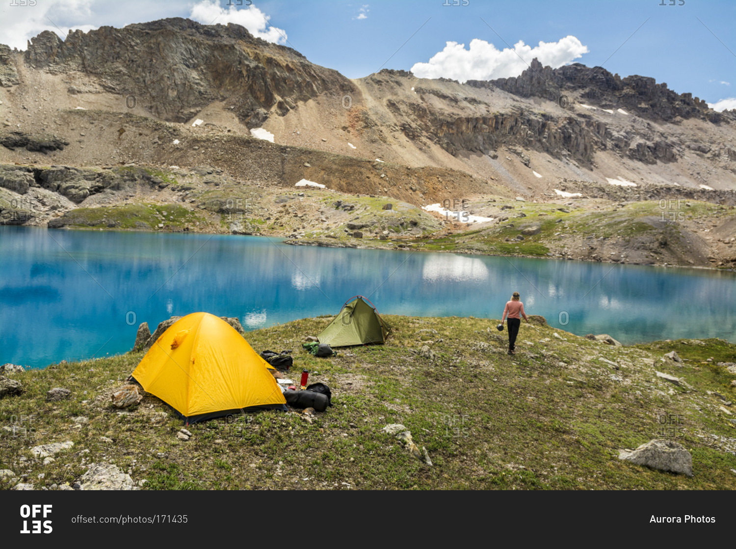 A woman camping near blue lake, San Juan National Forest, Silverton, Colorado.