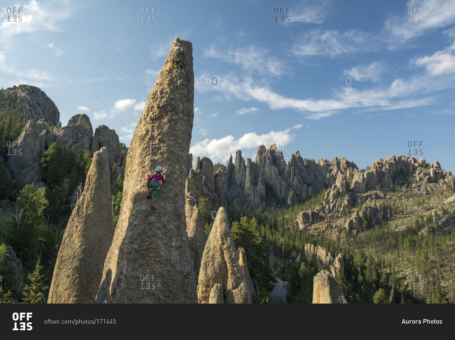 A young girl rock climbing in the Black Hills, Custer State Park, Hill City, South Dakota.