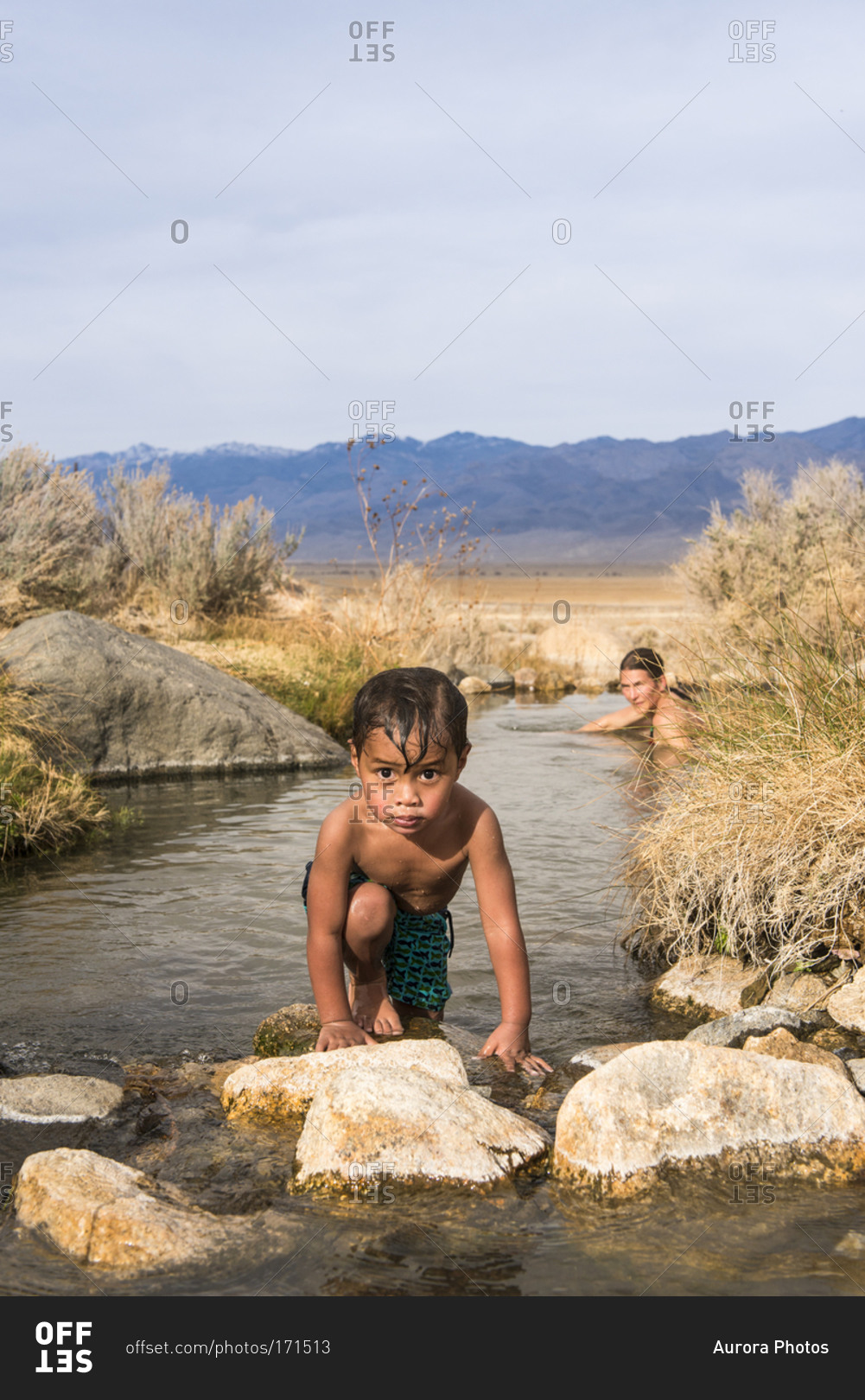 Child and mother playing in hot springs