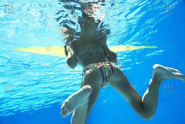 hand in Indomitable ammunition Underwater view of woman in bikini. stock photo - OFFSET