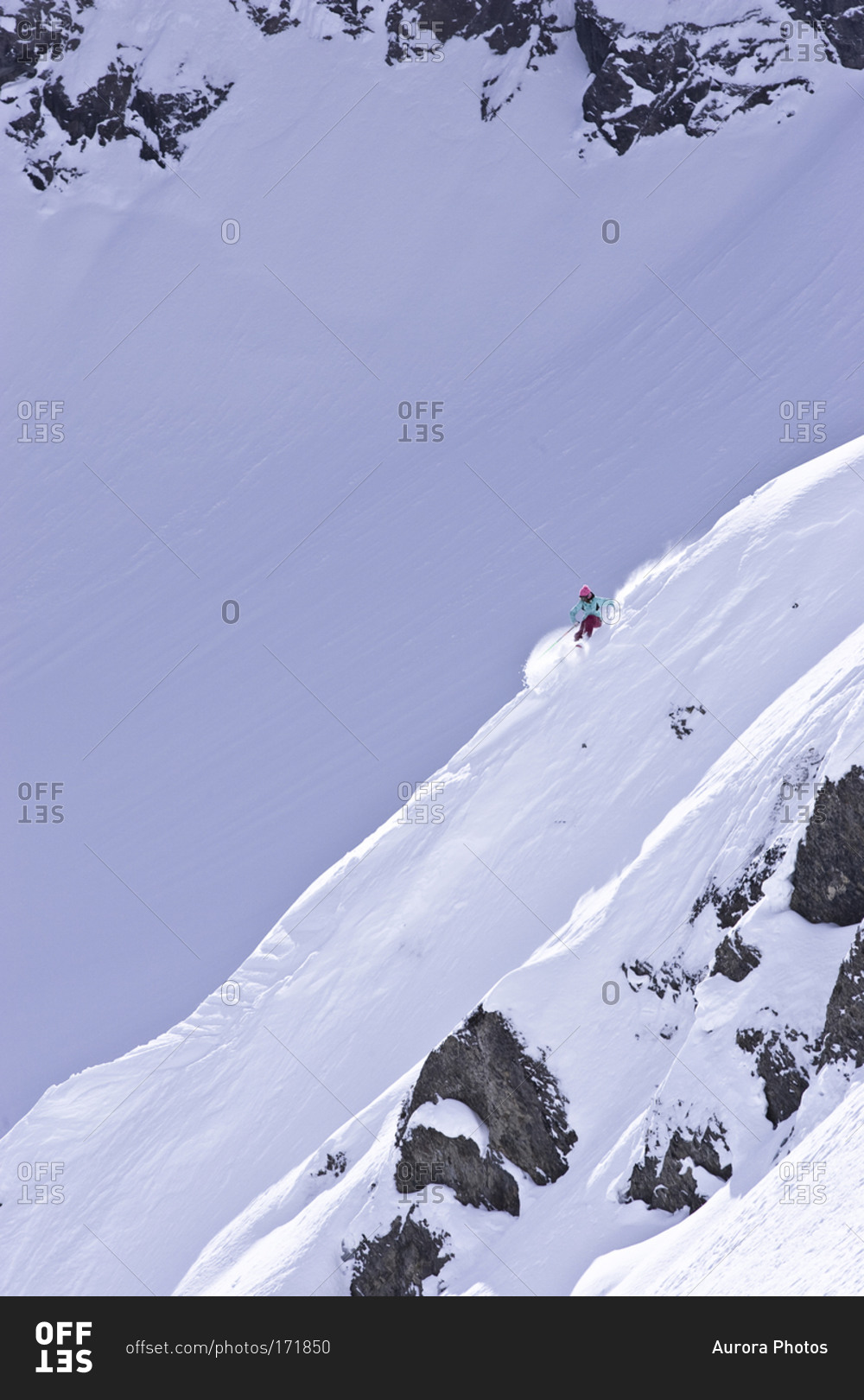 Woman skiing down a steep slope in Fernie, Canada