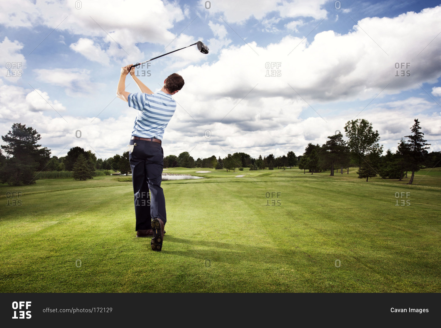 Golfer teeing off in a golf course