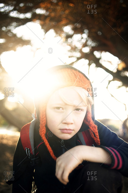 Portrait of young boy glaring at camera