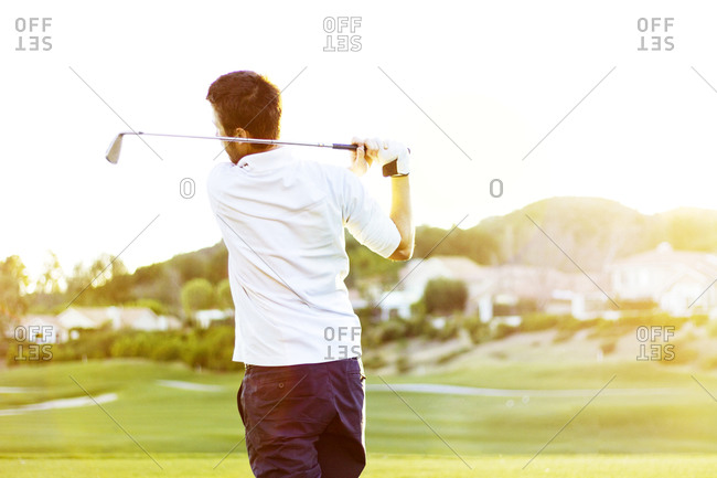 Man Swinging Golf Club Stock Photo Offset