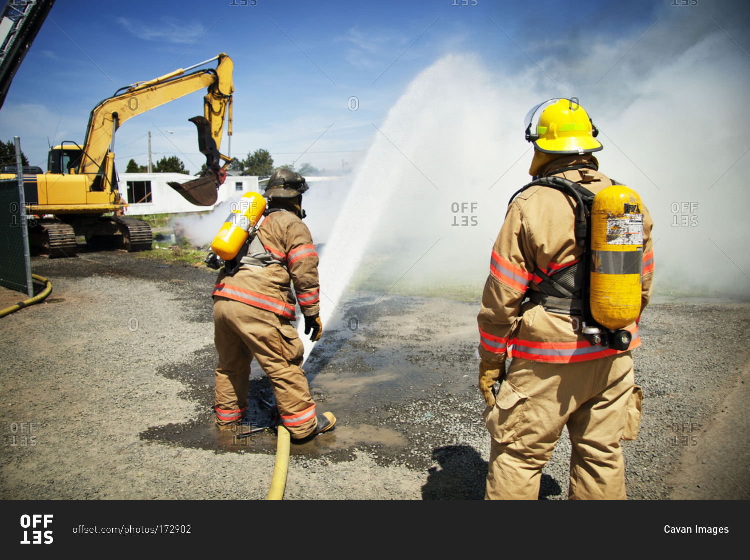 A fireman sprays water on a fire
