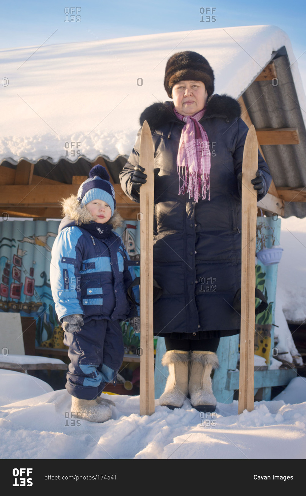 Mother and son posing with wooden skis