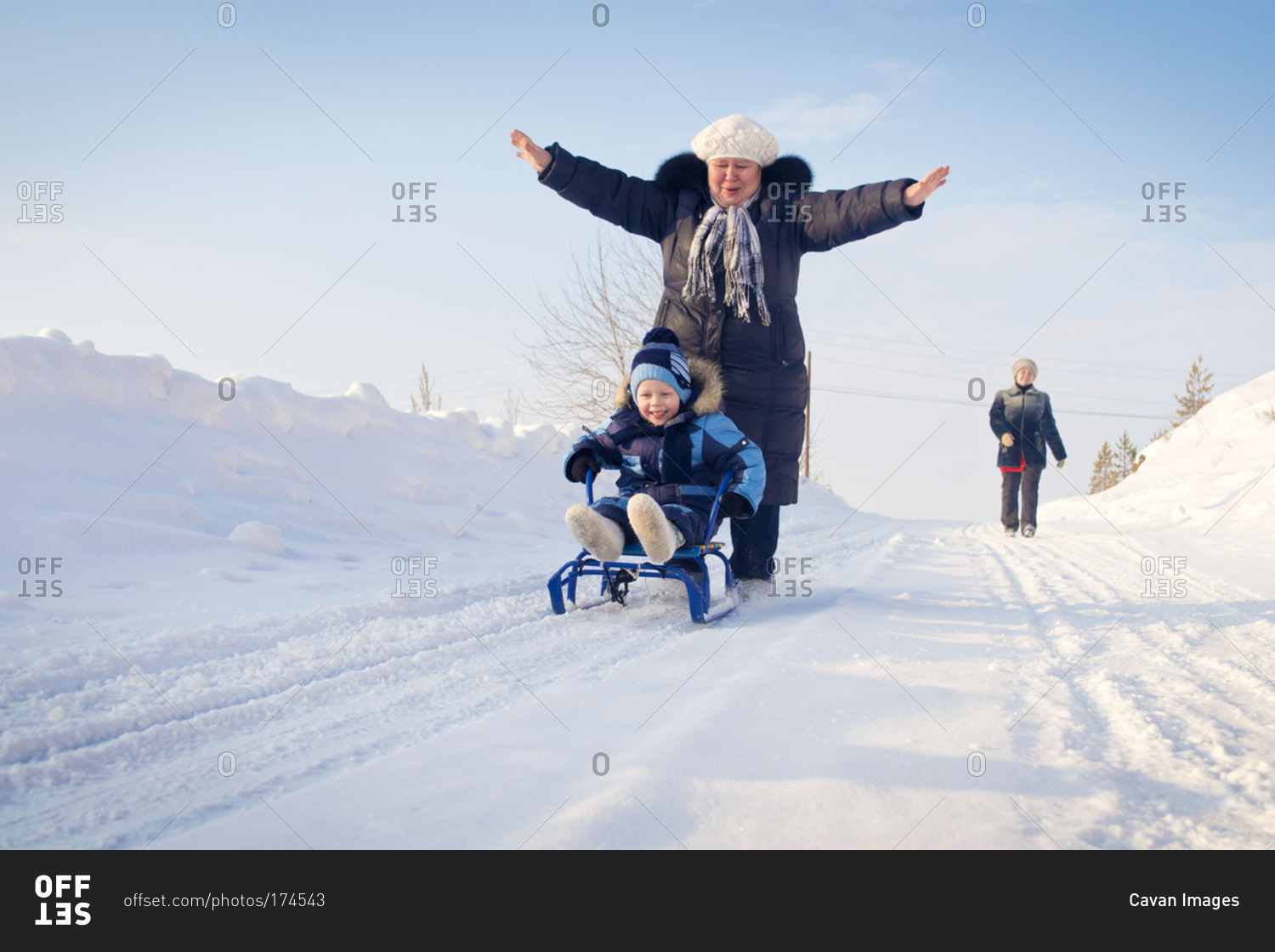 Family sledding down a snow covered hill