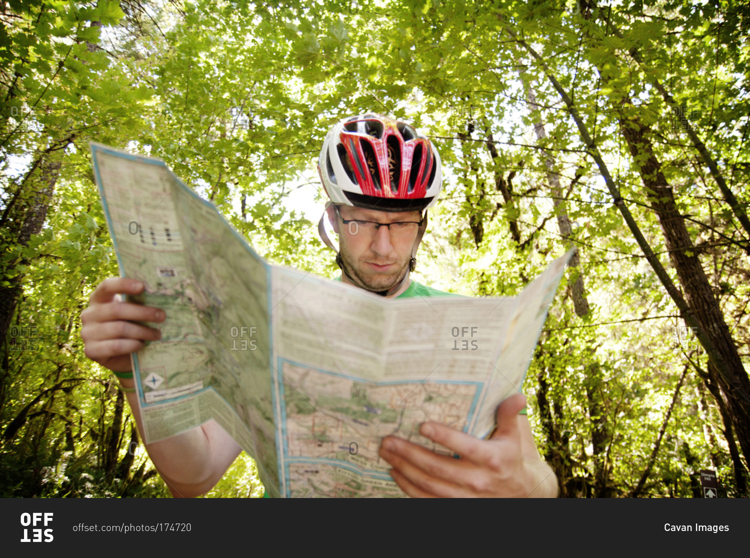 A man looks at a map in the woods