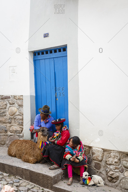 Cuzco, Peru - January 5, 2013: Quechua women with a llama and a lamb in the San Blas neighborhood, Cuzco, Peru.