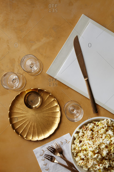 Popcorn on a table with dishware