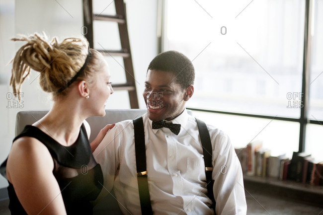 A young couple sits together in formalwear