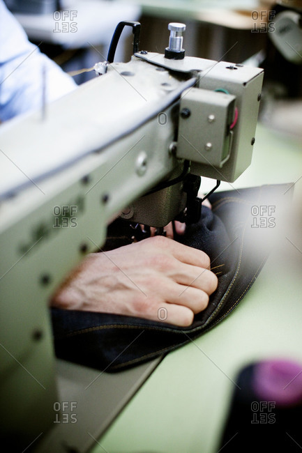 Person sewing with industrial machine
