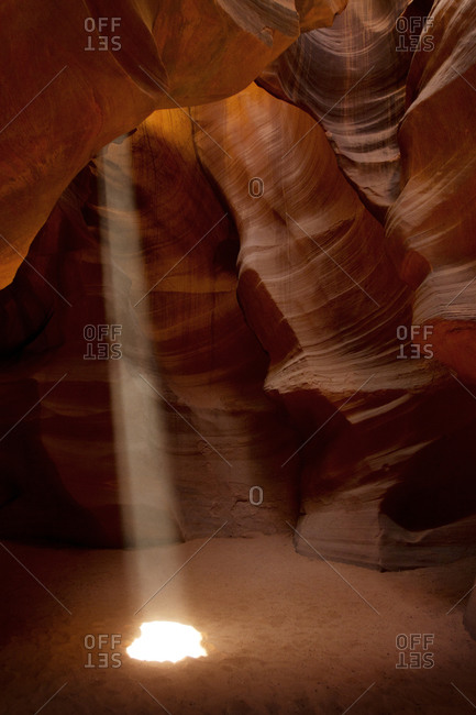 Light shines through a crack in a canyon in Antelope Canyon, Utah