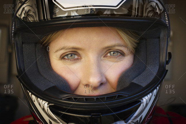 A woman in a motorcycle helmet