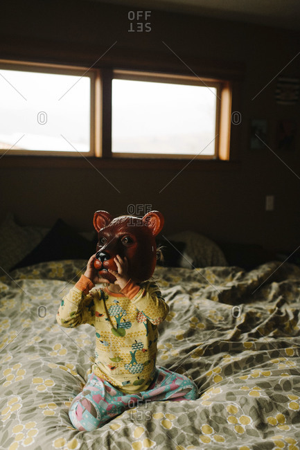 Child Sitting On Bed Wearing Bear Mask Stock Photo Offset