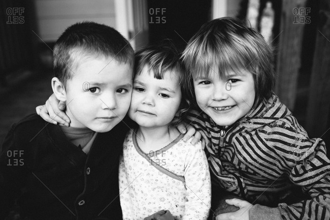 Black and white of three young children stock photo - OFFSET