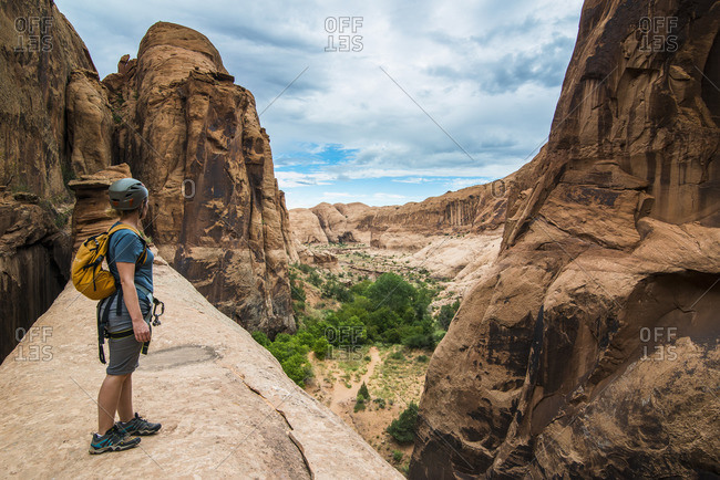 Moab, Utah, United States of America - September 8, 2014: Woman standing on a giant arch