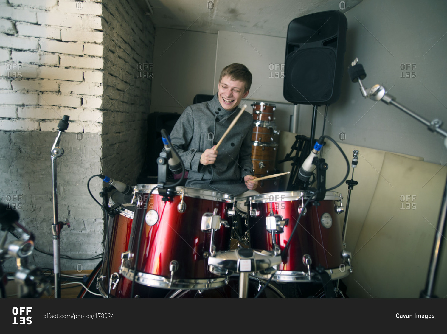 Young Musician Playing the Drums in Band stock photo OFFSET