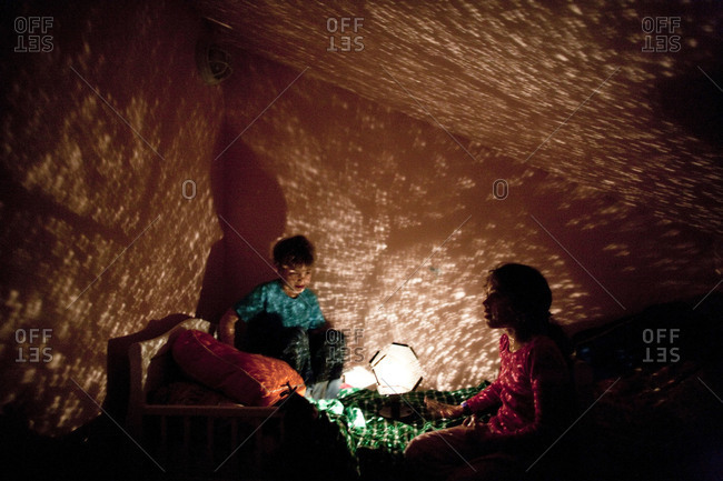 Children watching the projections of a night light
