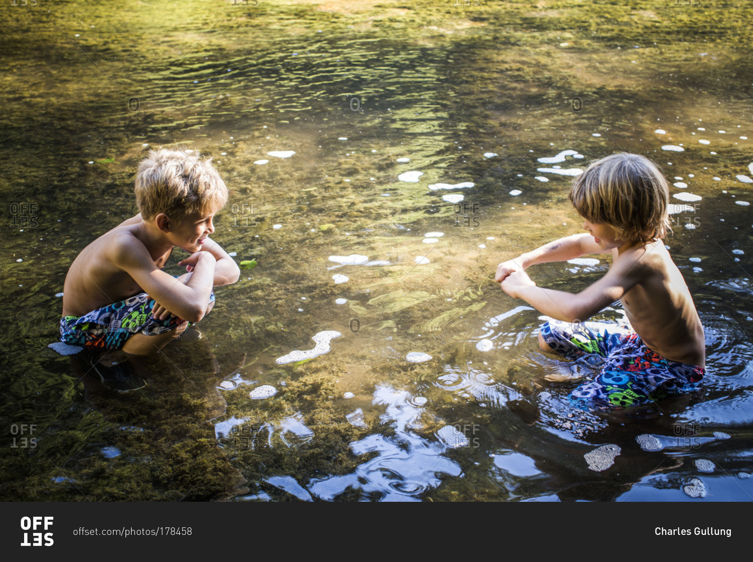 Brothers playing in the river