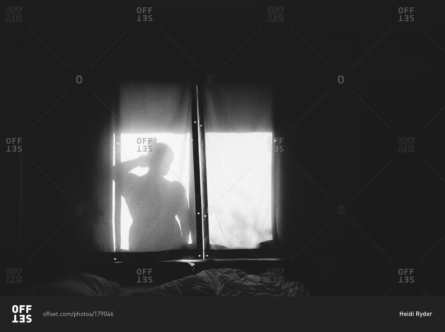 Black and white silhouette of woman in window