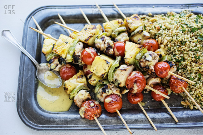 Pineapple chicken skewers served with quinoa