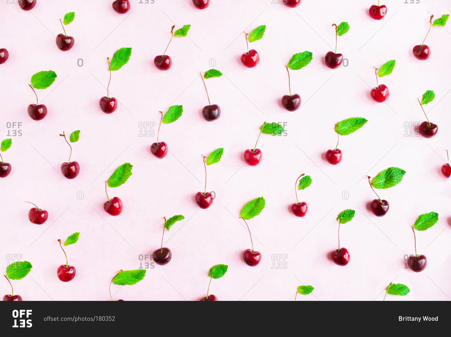 Cherries with stems laid out in pattern