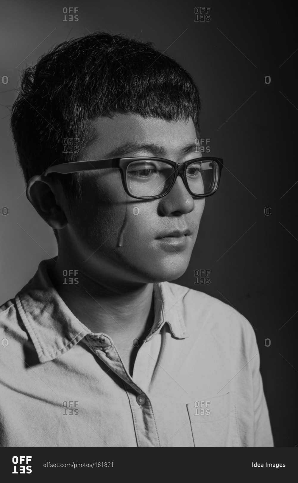 Young Asian man crying
