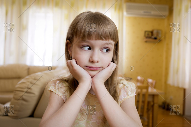 A young girl resting in her living room