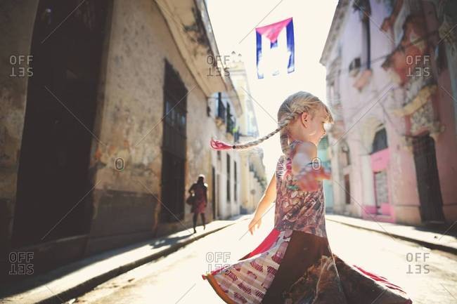 Girl twirling in Havana street, Cuba